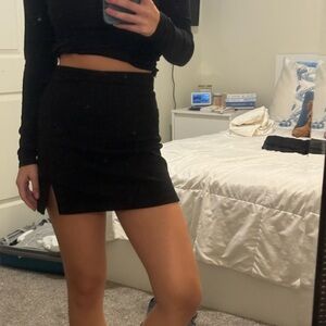 xs black corduroy mini skirt with a small leg slit